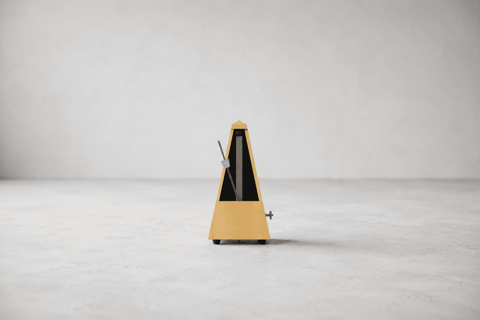A single wind-up mechanical metronome with a pale wooden pyramid body and an exposed pendulum arm, standing alone on a plain pale grey surface against a plain pale grey wall, with wide empty space on every side
